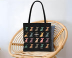 Black tote bag with colorful dog pattern on a name text