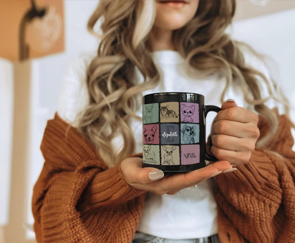 Person holding a black mug with colorful designs initial name text