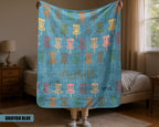 Person holding a blue Disk Golf blanket with colorful pattern in a room.