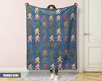 Person holding a colorful 'bigfoot' pattern blanket with name printed on it.