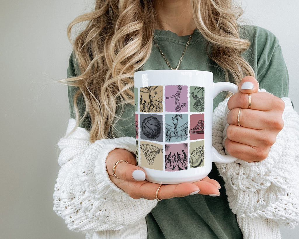 Person holding a mug with a colorful basketball design.