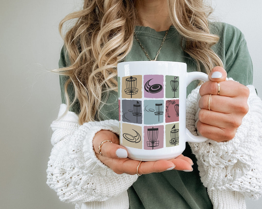 Person holding a mug with coffee-themed design against a neutral background
