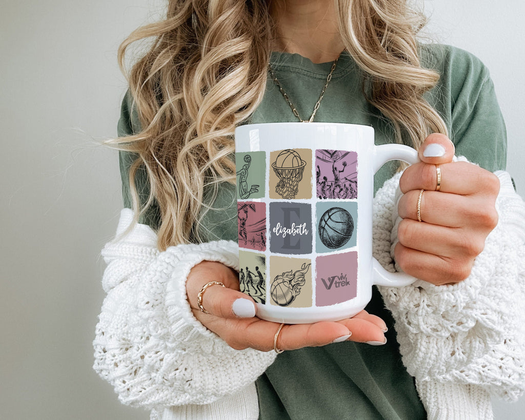 Person holding a mug with decorative Basketball design and text.