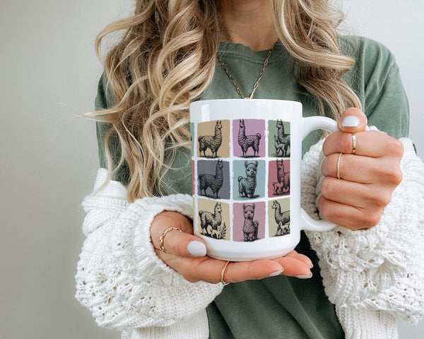 Person holding a mug with llama design.