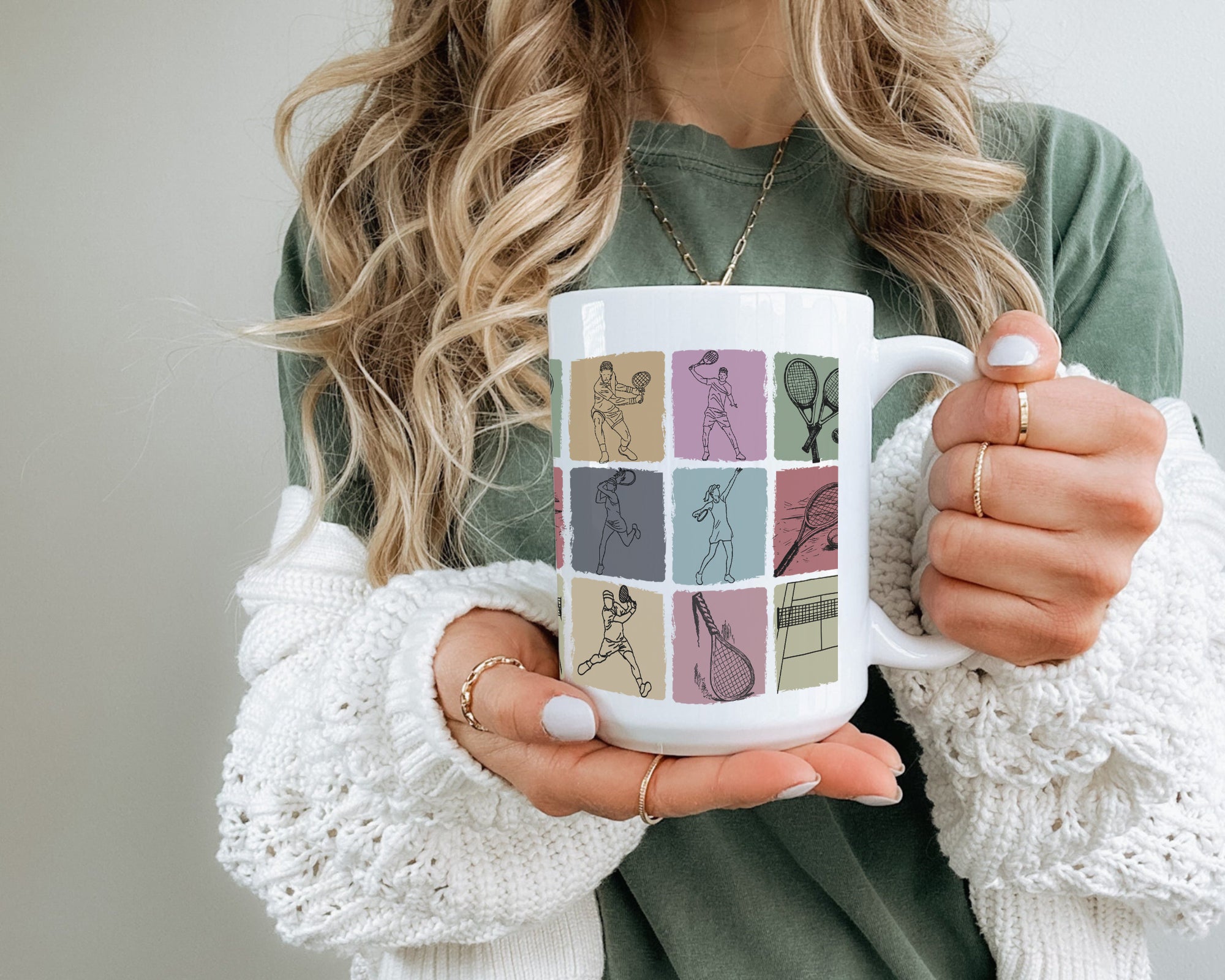 Person holding a mug with sports-themed design