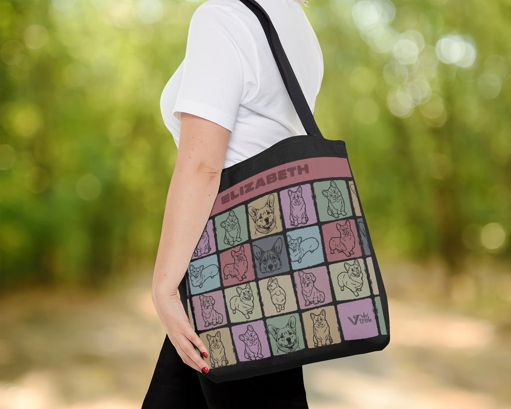 Person holding a tote bag with dog illustrations and text outdoors
